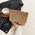 Brown velvet quilted chain bag with gold hardware shown in a lifestyle setting - Brown