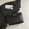 Black quilted tote bag with silver bow buckle and elegant metal chain strap for women - Black