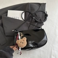 Glossy black croissant crossbody bag with a cute plush bear charm and leather strap - Black With Pendant