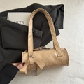 Chic beige cylinder baguette bag featuring a stylish side bow and soft PU leather texture - Khaki