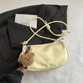 Chic cream yellow dumpling crossbody bag with cute teddy bear charm and knotted strap - Yellow with Pendant