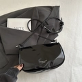 Glossy black leather dumpling bag with knotted strap and minimalist logo detail - Black without Pendant