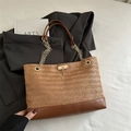 Braune gewebte Tote-Bag mit Lederboden und Kettenriemen auf grauem Blazer - Braun