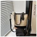 Detail of straw bucket bag featuring cream weaving, black leather trim and lace ribbon - Black