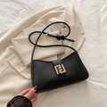 Chic black underarm bag with gold geometric buckle and knotted strap detail - Black