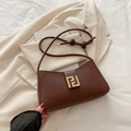Chic brown matte leather underarm bag with gold geometric buckle on beige blazer - Brown