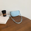 Light blue crescent saddle bag in pebble leather with knotted rope strap and metal beads - Blue