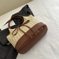 Straw woven tote bag with brown leather trim and bow detail on textured white fabric - Brown