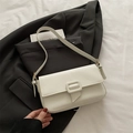 Elegant cream-white textured baguette shoulder bag with stylish buckle strap for women - White