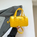 Bright yellow Boston handbag with heart-shaped quilting and silver butterfly charm - Yellow