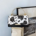 Fashionable cow print tote bag with gold circular metal handle and chain strap for women - Black