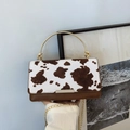 Cow print crossbody bag with golden ring handle and chain strap for women - Brown
