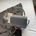 Light blue woven shoulder bag with a curved flap and braided handle for women - Blue