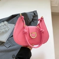 Pink leather saddle bag with gold D-buckle and elegant knotted handle design - Pink