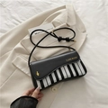 Retro piano pattern crossbody bag in black and white with gold music lettering - Black