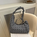 Gingham bow shoulder bag with shirred handle on a chair in a cozy lifestyle setting - Black