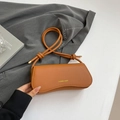 Orange-brown lychee leather underarm bag with decorative knot and golden hardware - Brown