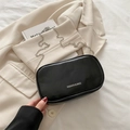 Chic black PU leather mini square makeup bag with silver chain strap on beige blazer - Black