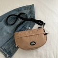 Minimalist khaki nylon crescent fanny pack with adjustable strap on denim background - Khaki