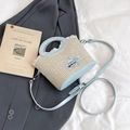 Blue woven straw bucket bag with sweet bow and lace detail on a stylish backdrop - Blue
