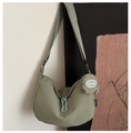 Detail of pea green nylon crescent tote with adjustable strap and small coin purse - Green