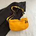 Fashionable bright yellow nylon crossbody bag with adjustable strap on a black blazer - Yellow