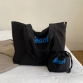 Large black canvas tote and drawstring bag set featuring blue Beach lettering design - Black