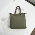 Olive green large nylon tote bag with colorful striped handles and eye logo detail - Green
