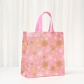 Pink Christmas non-woven gift bag featuring golden snowflakes and festive candy patterns - Snowflake Candy Pattern (5054-3)