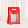 Detail of red gift box featuring a clear square window and a decorative silk bow tie - 16x12x7cm / Red