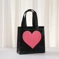 Detail showing cross-weave texture of a black non-woven gift bag with a pink heart - 9059 Black / 20x20x9