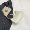 Minimalist cream-colored crescent shoulder bag with light gold hardware on white fabric - White
