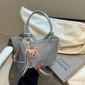Silver metallic bucket bag with a brown teddy bear charm and elegant knotted handle - Silver with Charm
