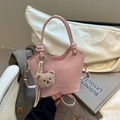Pink fashion bucket bag with plush bear charm and striped scarf detail - Pink With Pendant