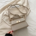 Minimalist metallic gold woven crossbody bag with gold twist lock and shoulder strap - Gold