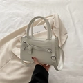 Creamy white bow-knot crossbody bag with silver buckles and elegant top handles - White
