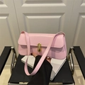 Bolso de hombro de cuero rosa con hebilla en U dorada en un ambiente elegante - Rosa