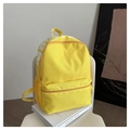 Detail of yellow nylon backpack featuring side mesh pocket and white letter prints - Yellow