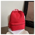 Detail of red nylon student backpack with side mesh pocket and white graphic print - Red