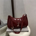 French style dark red patent leather baguette bag with golden buckle on a stand - Red