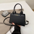 Fashionable black crocodile pattern crossbody bag with knotted handle and gold text logo - Black