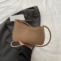 Minimalist beige half-moon shoulder bag with fine leather texture and gold hardware - Khaki