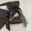 Dark brown patent leather bow shoulder bag with silver rivets in a stylish crescent shape - Brown