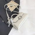 Detalle de bolso blanco con hebilla G plateada, colgante de perlas y encaje fino - Sin colgante / Blanco