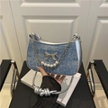 Blue denim shoulder bag with silver bow accent and pearl chain strap detail - Blue