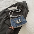 Blue denim shoulder bag with silver bow accent and pearl chain in stylish knot strap - Dark Blue