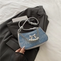 Blue denim underarm bag with silver bow and pearl chain in trendy Y2K aesthetic - Blue