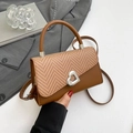 Brown woven patchwork crossbody bag featuring a silver heart buckle and top handle - Brown