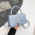 Light blue patchwork woven handbag featuring a silver heart-shaped metal twist lock - Blue