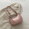 Pink crescent underarm bag with glossy finish and silver butterfly charm detail - Pink
